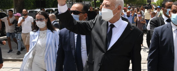 (FILES) In this file handout picture provided by the Tunisian Presidency's official Facebook Page on August 1, 2021 shows President Kais Saied (C) gesturing as he walks protected by security while touring through Habib Bourguiba avenue in the centre of the capital Tunis.
TUNISIAN PRESIDENCY / AFP
