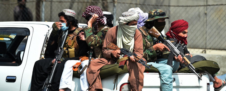 FILE: Taliban fighters guard outside the airport in Kabul on 31 August 2021. Picture: AFP