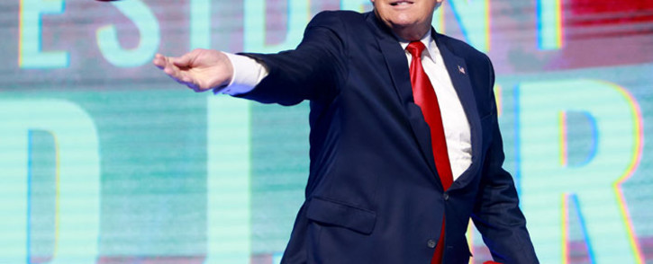 Former US President Donald Trump tosses hats into the crowd during the Turning Point USA Student Action Summit held at the Tampa Convention Center on 23 July 2022 in Tampa, Florida. Picture: Joe Raedle/Getty Images/AFP
