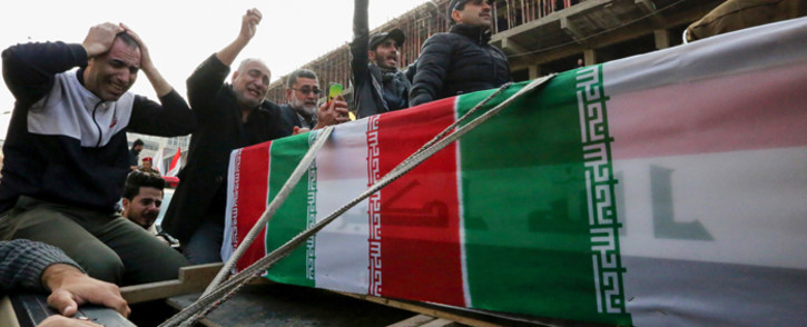 Iraqis mourn over a coffin during the funeral procession of Iraqi paramilitary chief Abu Mahdi al-Muhandis and Iranian military commander Qasem Soleimani, and eight others, in Kadhimiya, a Shiite pilgrimage district of Baghdad, on January 4, 2020.  Picture: AFP.