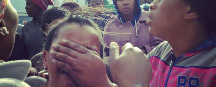 FILE: A woman weeps after her shack was destroyed by fire as police carried out mass evictions in Nomzamo near Strand in Cape Town. Picture: Carmel Loggenberg/EWN.