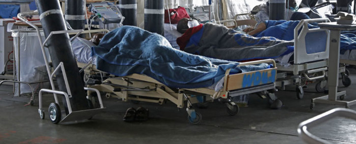 Patients are seen lying on hospital beds inside a temporary ward dedicated to the treatment of possible COVID-19 coronavirus patients at Steve Biko Academic Hospital in Pretoria on 11 January 2021. Picture: Phill Magakoe/AFP