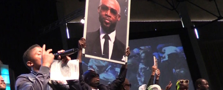 Mourners hold a placard with Mduduzi ‘Mandoza’ Tshabalala’s face during the Kwaito legend’s funeral at Grace bible Church in Soweto on 23 September 2016. Picture: Katleho Sekhotho/EWN.