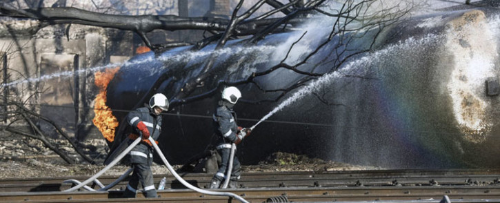 Firefighters spray water on a train which derailed in the northeastern Bulgarian village of Hitrino on December 10, 2016. Picture:  AFP.