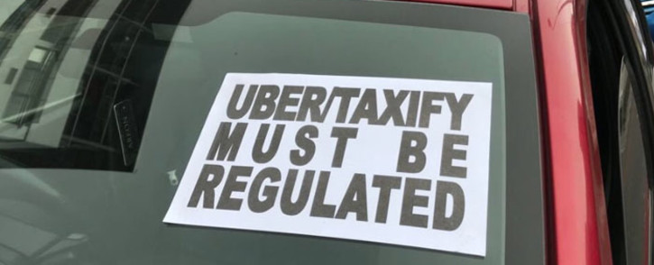 A message is seen on one of the cars that participated in a protest by Uber and Taxify driver in Green Point, Cape Town. Picture: EWN