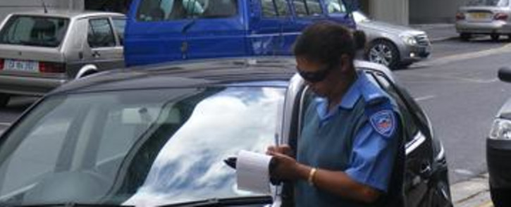 A traffic officer writes out a parking ticket in Cape Town. Picture: Nathan Adams/Eyewitness News