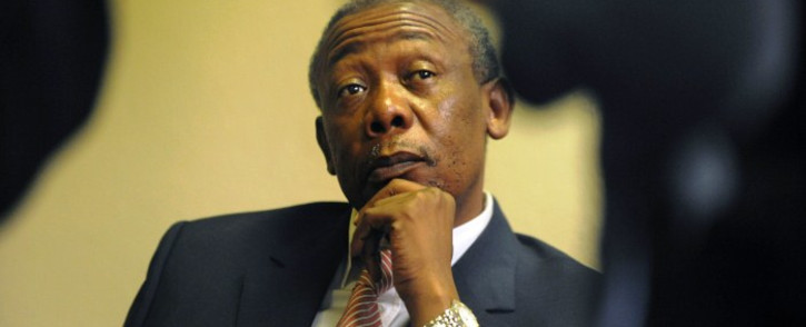 FILE: Jackie Selebi looks on as he speaks with his legal team ahead of his corruption trail at the high court in Johannesburg on 14 April, 2009. Picture: AFP.