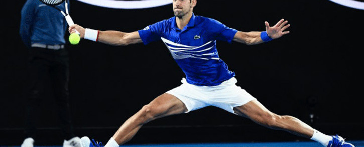 Serbia's Novak Djokovic hits a return against France's Lucas Pouille during their men's singles semi-final match on day 12 of the Australian Open tennis tournament in Melbourne on 25 January, 2019. Picture: AFP.