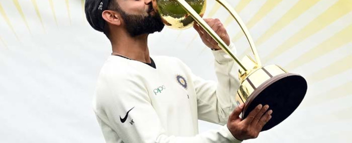 FILE: In this file photo taken on 7 January 2019 India's captain Virat Kohli kisses the Border-Gavaskar trophy as the Indian team celebrates their series win on the fifth day of the fourth and final cricket Test against Australia at the Sydney Cricket Ground in Sydney. Picture: AFP