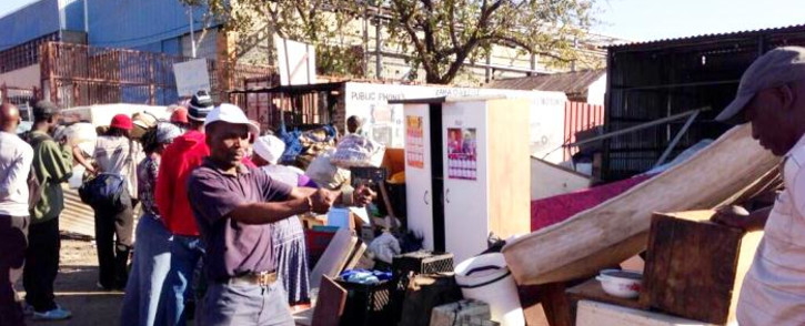 Evicted Alexandra residents rummage through a pile of their belongings on 4 June, 2014. Picture: Lesego Ngobeni/EWN.