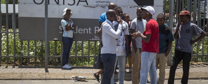 Students stand outside the Unisa Sunnyside campus in Pretoria after chaos broke out during registration on 15 January 2018. Picture: Ihsaan Haffejee/EWN