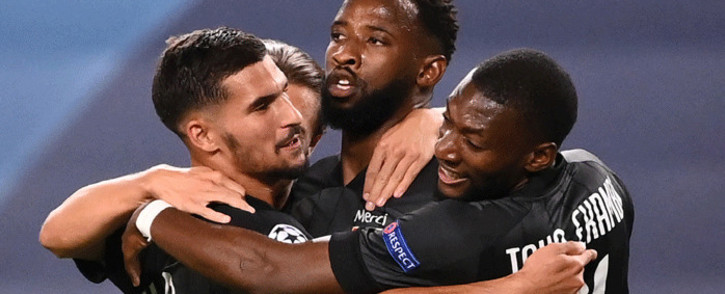 Lyon's French forward Moussa Dembele (2R) celebrates scoring his team's second goal during the UEFA Champions League quarter-final football match between Manchester City and Lyon at the Jose Alvalade stadium in Lisbon on 15 August 2020. Picture: AFP
