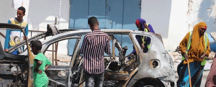 FILE: People start cleaning debris at the site where a car bomb exploded near the Somali parliament in Mogadishu, Somalia, on 8 January 2020.  Picture: AFP