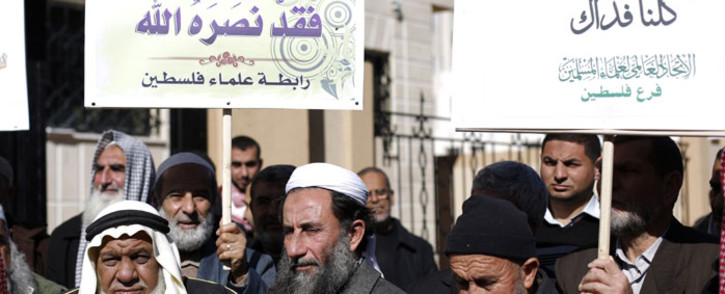 Palestinian men, holding placards bearing slogans praising Islam's Prophet Mohammed, take part in a demonstration in protest against a recent cartoon of the prophet that was published by the French satirical magazine Charlie Hebdo. Picture: AFP. 