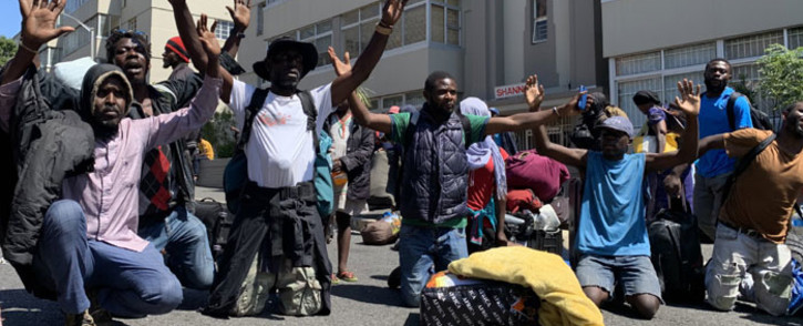 Foreign nationals plead not to be moved by the City of Cape Town officials on 2 March 2020. Picture: Kaylynn Palm/EWN