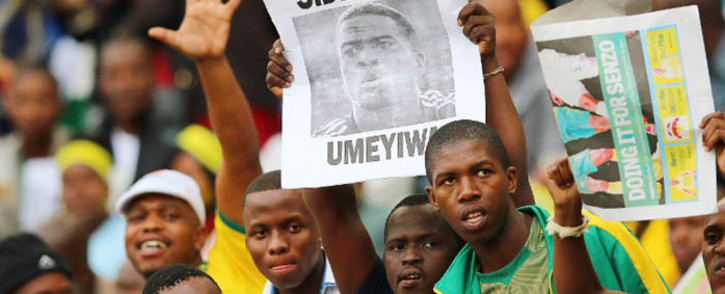 South African supporters hold a portrait of murdered Bafana Bafana captain and goalkeeper Senzo Meyiwa during the Africa Cup of Nations 2015 qualifying football match South Africa vs Sudan, at the Moses Mabhida Stadium in Durban, on 15 November, 2014. Picture: AFP