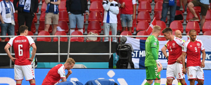 Medics attend to Denmark's midfielder Christian Eriksen after he collapsed during the UEFA EURO 2020 Group B football match between Denmark and Finland at the Parken Stadium in Copenhagen on 12 June 2021. Picture: Jonathan Nackstrand/AFP