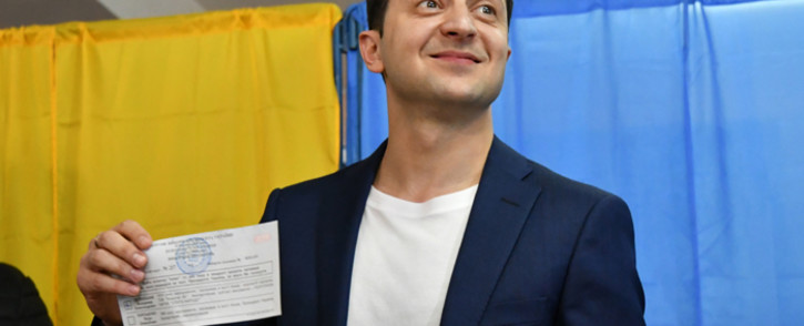 Comedian and presidential candidate Volodymyr Zelensky shows his ballot to the media at a polling station during the second round of Ukraine’s presidential election in Kiev on 21 April 2019. Picture: AFP.