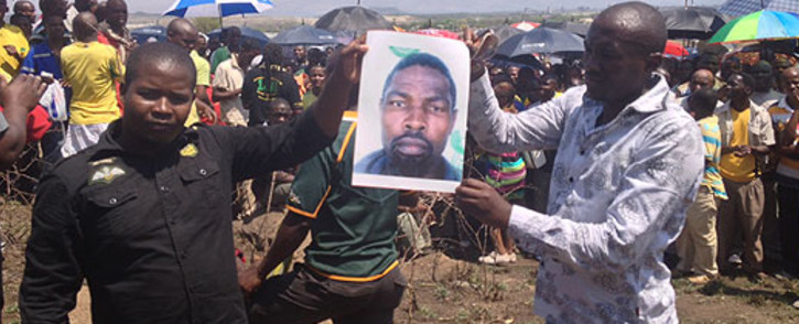 Amplats miners hold up a picture of their comrade who was killed who was killed allegedly by police on 4 October 2012. Picture:Govan Whittles/EWN 