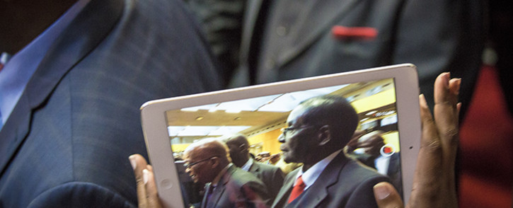 FILE: Zimbabwean President Mugabe is caught on an iPad as he makes his way through the University of Fort Hare sports complex and onto stage to the singing and cheering of the audience. Picture: Thomas Holder/EWN.