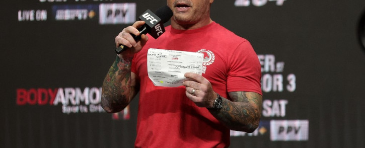 FILE: UFC commentator Joe Rogan announces the fighters during a ceremonial weigh-in for UFC 264 at T-Mobile Arena on 9 July 2021 in Las Vegas, Nevada. Stacy Revere/AFP