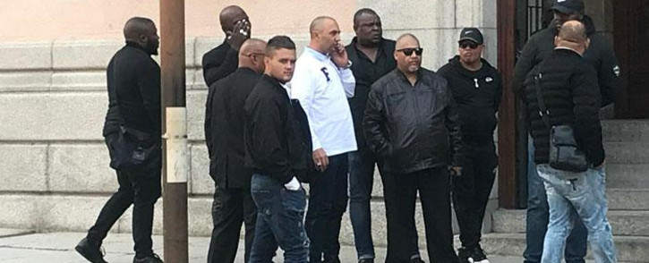 FILE: Nafiz Modack, pictured wearing a white shirt, is surrounded by security personnel outside the Cape Town Regional Court on 16 April 2019. Picture: Shamiela Fisher/Eyewitness News.