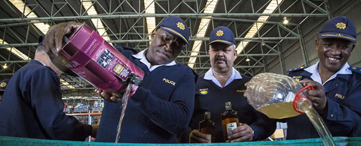 Acting Western Cape Police Commissioner Major General Thembisile Patekile (L) headed the disposal of 10 000 litres of confiscated alcohol from unlicensed liquor vendors in the Western Cape. Picture: Thomas Holder/EWN