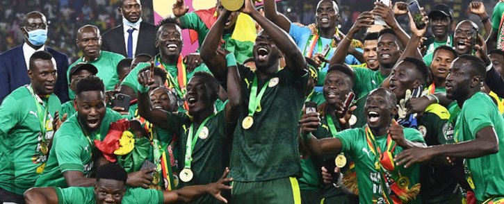 Senegal's players celebrate with the trophy after winning the Africa Cup of Nations (CAN) 2021 final football match between Senegal and Egypt at Stade d'Olembe in Yaounde on 6 February 2022. Picture: CHARLY TRIBALLEAU/AFP