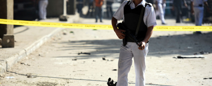 FILE: An Egyptian policeman stands guard at the site of a powerful bomb explosion, that ripped through the Italian consulate, killing one person, in the Egyptian capital, Cairo, on 11 July, 2015. Picture: AFP.