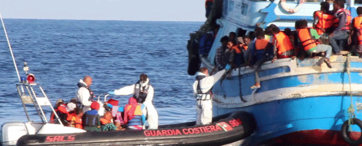A video grab released by the Italian Coast Guards on 23 August 2015 shows migrants waiting on an overcrowded boat being helped during a rescue operation off the coast of Libya as part of the Frontex-coordinated Operation Triton. Picture: AFP "