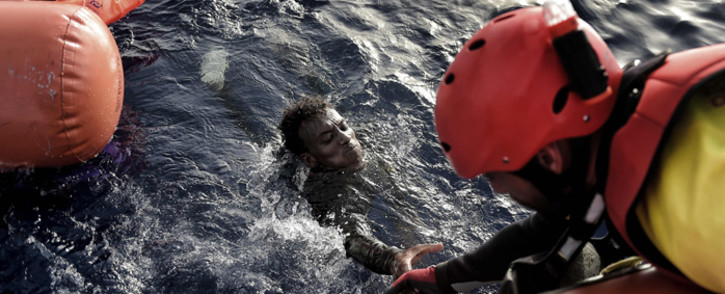 FILE: A migrant is rescued from the Mediterranean sea by a member of Proactiva Open Arms NGO north of Libya on 3 October 2016. Picture: AFP
