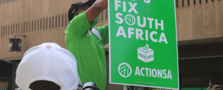 Action SA leader Herman Mashaba hangs a poster during the launch of the party's election campaign on 9 September 2021. Picture: @Action4SA/Twitter.
