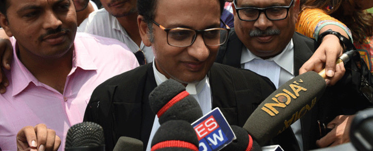 Indian Supreme Court advocate Saif Mahmood (C) meets with the press outside the Supreme Court in New Delhi on 22 August 2017, after India's top court on banned a controversial Islamic practice that allows men to divorce their wives instantly. Picture: AFP.