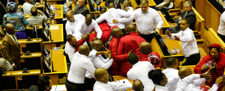 Security officials remove EFF members from the National Assembly after they disrupted President Zuma’s 2017 State of the Nation Address. Picture: AFP.