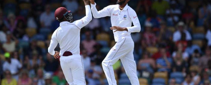 West Indies Roston Chase and teammate celebrate a wicket during their clash with England. Picture: @windiescricket/Twitter.