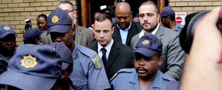 Oscar Pistorius leaves the Pretoria High Court under heavy security after the second day of his murder trial on 4 March 2014. Picture: Sebabatso Mosamo/EWN.