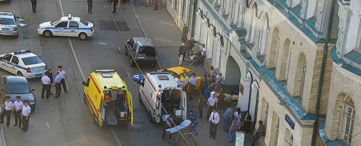 A handout CCTV picture released by the Moscow Municipal Traffic Regulation centre CODD, shows Russian police officers and paramedics working at the scene, after a taxi drove into a crowd injuring seven people on 16 June, 2018 in the centre of Moscow. Picture: AFP.