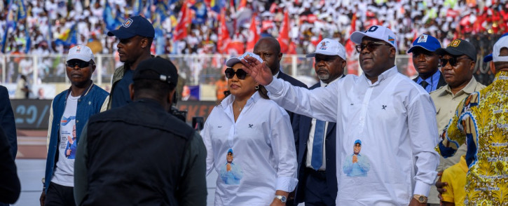 Incumbent President of the Democratic Republic of the Congo and presidential candidate Felix Tshisekedi of the Union for Democracy and Social Progress (UDPS) political party (3rd R) waves to his supporters at the Stade des Martyrs during his first campaign rally as the electoral campaign officially kicks off ahead of the 2023 general elections in Kinshasa on 19 November2023. Picture: AFP