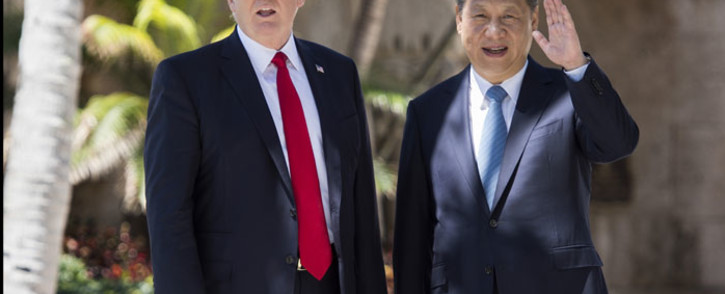 Chinese President Xi Jinping (R) waves to the press as he walks with US President Donald Trump at the Mar-a-Lago estate in West Palm Beach, Florida, April 7, 2017. Picture: AFP.