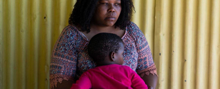 1 September 2021: Vuyokazi Yvone Mathebula, whose younger sister Nonhle Gloria Aphane was murdered in June, comforts one of Aphane’s three children. Picture: New Frame.