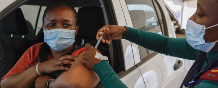 FILE: A woman receives a dose of the Johnson and Johnson COVID-19 vaccine from a healthcare worker at the Zwartkops Raceway in Centurion on 13 August 2021. Picture: Phill Magakoe/AFP