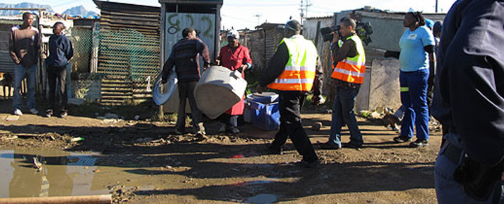 City of Cape Town workers clean portable toilets in Gugulethu on 11 June 2013. Picture: Tammy Abrahams/EWN