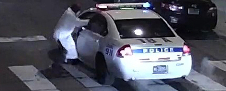 This video still image obtained 8 January, 2016 courtesy of the Philadelphia Police Department, shows a shooting suspect and police car on 7 January, 2016 in Philadelphia, PA. A self-professed sympathiser of the Islamic State extremist group shot and seriously wounded a police officer in Philadelphia, opening fire multiple times at point blank range with a stolen weapon. Picture: AFP.