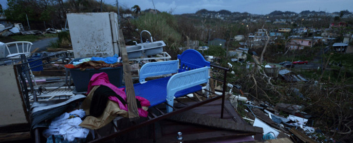 FILE: Debris is scattered around a destroyed house in the Acerolas neighbourhood, in Toa Alta, Puerto Rico, on 1 October 2017. Picture: AFP.