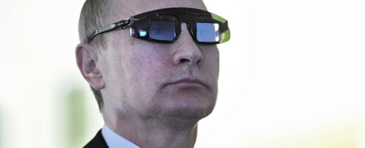 Russian President Vladimir Putin, wearing special glasses, looks on as he visits a laboratory at the Gornyy National Mineral Resources University on 26 January, 2015. Picture: AFP