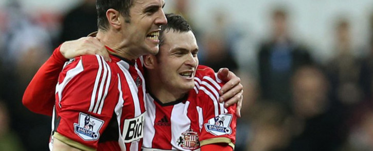 Sunderland's Irish defender John O'Shea (L) celebrates at the final whistle with goal-scorer, Sunderland's English midfielder Adam Johnson after the English Premier League football match between Newcastle United and Sunderland at St James' Park in Newcastle-upon-Tyne, north east England, on 21 December, 2014. Picture: AFP