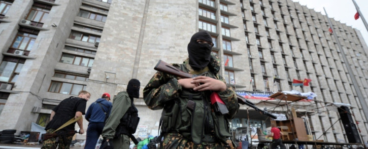 FILE: A pro-Russian militant guards a regional state building that was seized by separatists in eastern Ukrainian city of Donetsk on 2 June, 2014. Picture:AFP.