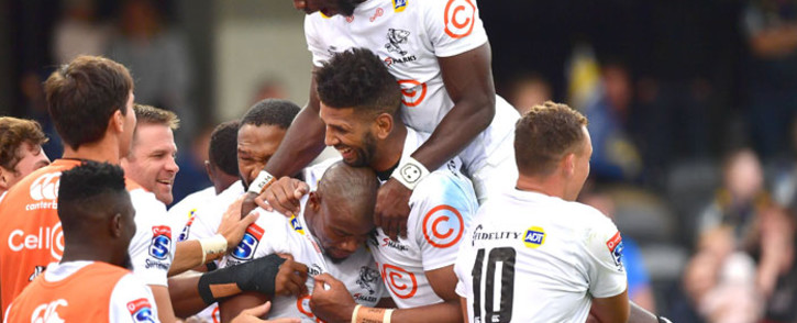 The Sharks' Madosh Tambwe (top) with teammates Hyron Andrews (centre R), Makazole Mapimpi (C) and Curwin Bosch (R) celebrate a try during the Super Rugby match against the Highlanders at the Forsyth Barr Stadium in Dunedin on 7 February 2020. Picture: AFP