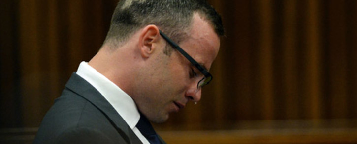 Oscar Pistorius weeps while listening to text messages given in evidence by cellphone analyst Francois Moller during his murder trial at the high court in Pretoria on 24 March 2014. Picture: Pool.