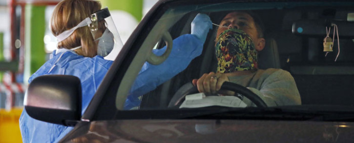 FILE: A Dis-Chem Pharmacy health professional collects a nasal swab for a COVID-19 coronavirus test at a drive-through testing site at a mall in Centurion on 9 April 2020. Picture: AFP